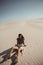 Safari Woman in Desert Outdoors, Dunes on the Background