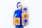 Safe contactless remote delivery of holiday gifts during coronavirus. A courier in blue uniform and protective medical mask,