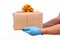 Safe contactless remote delivery of holiday gifts during the coronavirus pandemic. Close up. Courier hand in protective