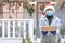 Safe delivery of gifts and packages for the holidays in quarantine during the coronavirus pandemic. A courier, a volunteer in a