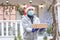Safe delivery of gifts and packages for the holidays in quarantine during the coronavirus pandemic. A courier, a volunteer in a