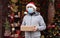 Safe delivery of gifts and packages for the holidays in quarantine during the coronavirus pandemic. A courier, a volunteer in a