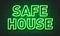 Safe house neon sign on brick wall background.