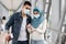 Safe Travels. Young muslim couple wearing medical mask applying sanitizer at airport