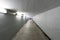 Safe and well lit underpass and concrete hallway underneath a train station