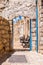 Safed street, bystreet, alley, backstreet with benches, ancient stone walls, arcs and blue white decorations