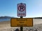 safeguard yoru valuables and no parking sign on beach