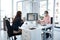 Safely working face-to-face. two businesspeople wearing face masks while working together in an office.