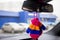 Safety of baby in car. children`s mittens with blue, orange and pink stripes hang on the rear view mirror of a modern