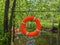 Safety equipment, lifebuoy or rescue buoy hanging on the fence near the boat station