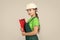 Safety expert. kid wear helmet on construction site. teen girl builder with building paper document. child on repairing