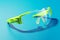 Safety eyewear focus Technological green glasses isolated on blue background