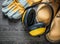 Safety gloves waterproof working boots earmuffs on wooden board