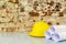 Safety helmet and drawings project on brick wall background