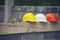 Safety helmet hard hat for engineer, safety officer, or architect, place on cement floor. Yellow and orange safety hat helmet