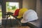 Safety helmet (hard hat) for engineer, safety officer, or architect, place on wooden floor.