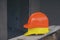 Safety helmet (hard hat) for engineer, safety officer, or architect, place on wooden floor.