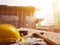 Safety helmet on table top with construction site in background