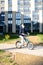 Safety in a modern European city. A little happy boy rides a bicycle through a closed courtyard in a multi-storey urban