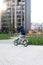 Safety in a modern European city. A little happy boy rides a bicycle through a closed courtyard in a multi-storey urban