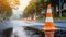 Safety orange cone on wet asphalt after rain. Plastic traffic cone. Road maintenance work