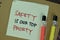 Safety Is Our Top Priority write on sticky notes isolated on Wooden Table