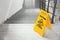 Safety sign with phrase Caution wet floor stairs