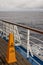 Safety warning marker Teak lined Promenade Deck of modern cruise ship.