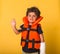 Safety on water for children. Funny confident four years old kid in life-jackets with hand shows stop sign. sitting on