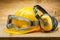 Safety of work. construction safety tools. yellow helmet blue goggles and earphones on wood background