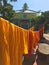 Saffron colour buddhist monk clothing drying on a clothesline in Vietnamg