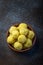 Saffron flavoured desiccated coconut ladoo in a wooden bowl