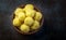 Saffron flavoured desiccated coconut ladoo in a wooden bowl