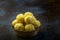 Saffron flavoured desiccated coconut ladoo in a wooden bowl