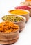 Saffron,paprika,sumac,turmeric,green pepper in a wooden bowl