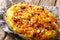 Saffron pilaf with dried fruits, carrots, orange zest, spices and nuts closeup on a plate. horizontal