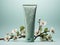 sage green cream tube on neutral green background with flowers, space for text, aesthetic cosmetic or pharmaceutical product