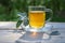 Sage tea in a glass mug on a wooden table, healthy hot drink and home remedy for coughs, sore throat, digestive problems,