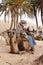 Sahara Desert, Tunisia. Beduin man getting camels ready for a camel ride across the African desert