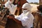 Sahara Desert, Tunisia. Beduin man getting camels ready for a ride across the desert