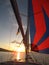 Saiing yacht under genaker sail in sunset.