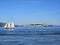 A sail boat crossing in front of Alcatraz Island in San Francisco California