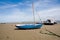 Sail boat moored with an anchor on the beach at low tide at Appledore beach North Devon