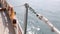 Sail boat navigating in the ocean sunny day showing the wooden parts and Closeup of the deck of a wooden antique