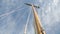 Sail boat navigating in the ocean sunny day showing the wooden parts and Closeup of the sail of a wooden antique