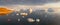 Sail boat with red sails cruising among ice bergs during sunset. Disko Bay, Greenland. Climate change and global warming