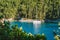 Sail boat yacht moored in the bay of Foki beach surrounded by cypress trees, Fiskardo, Cefalonia, Ionian, Greece