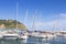 Sail Boats and yachts parked at docks of Blanes, Costa Brava, Spain. Sea port with white yachts on summer clear day