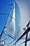 Sail tack with a sailing yacht in the wind with blue sky.