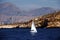 Sailboat across the coast of Benidorm city in Spain.